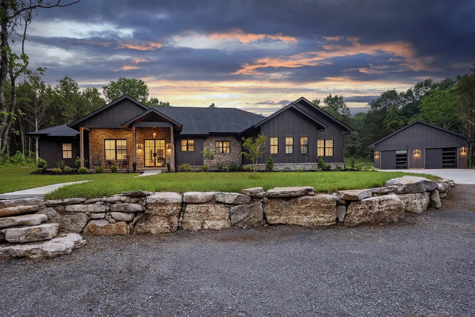 Custom modern farmhouse by Syndicate Design and Construction at dusk