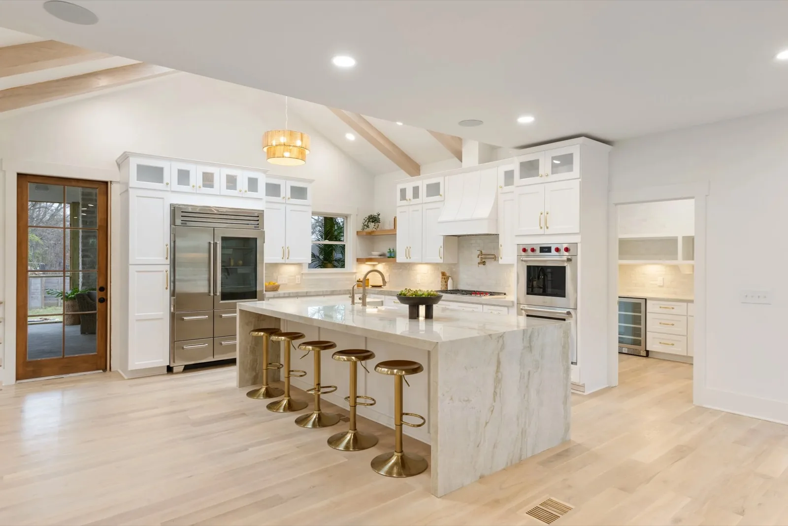 Custom kitchen with marble waterfall island built by Syndicate