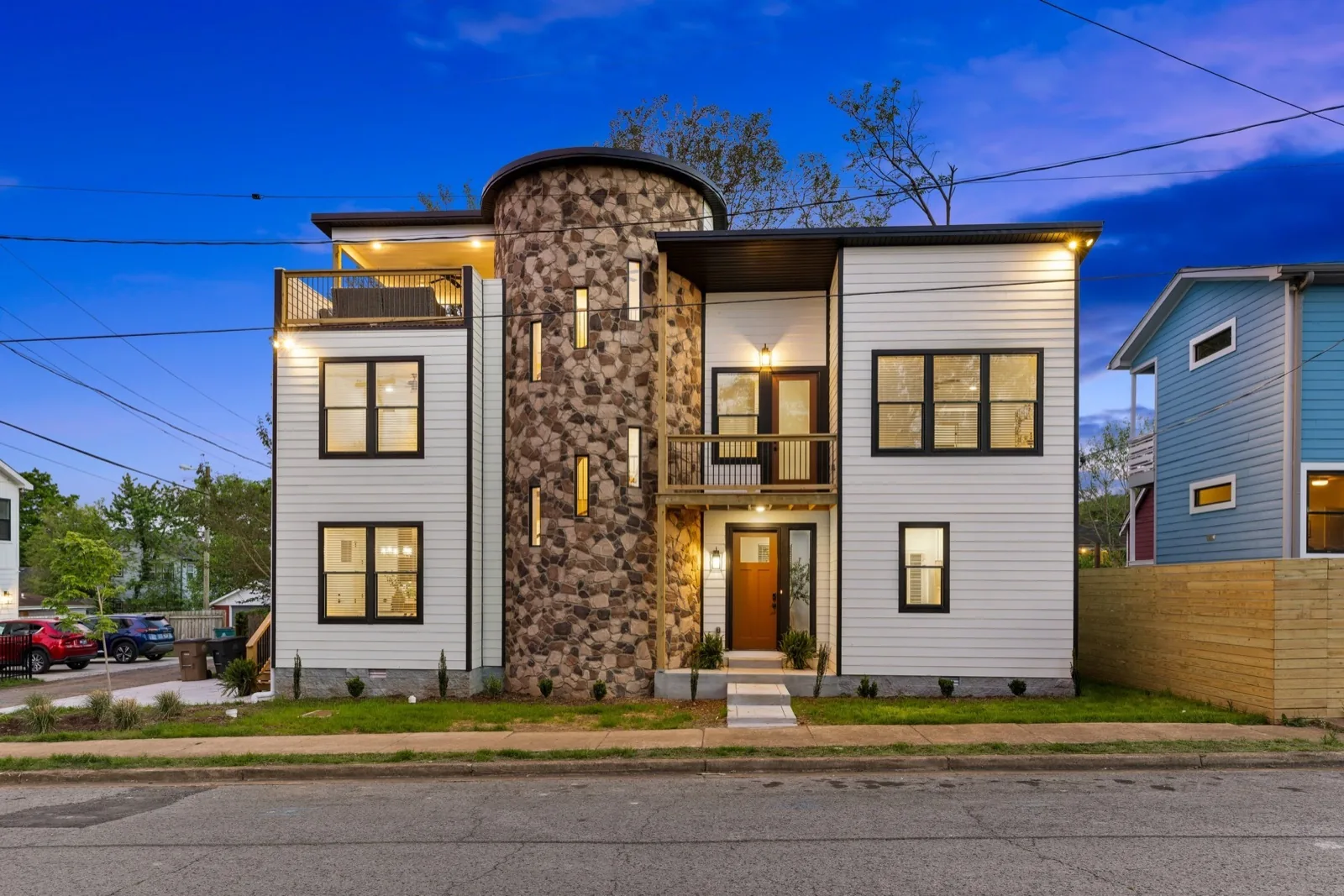 East Nashville modern home with stone turret at dusk